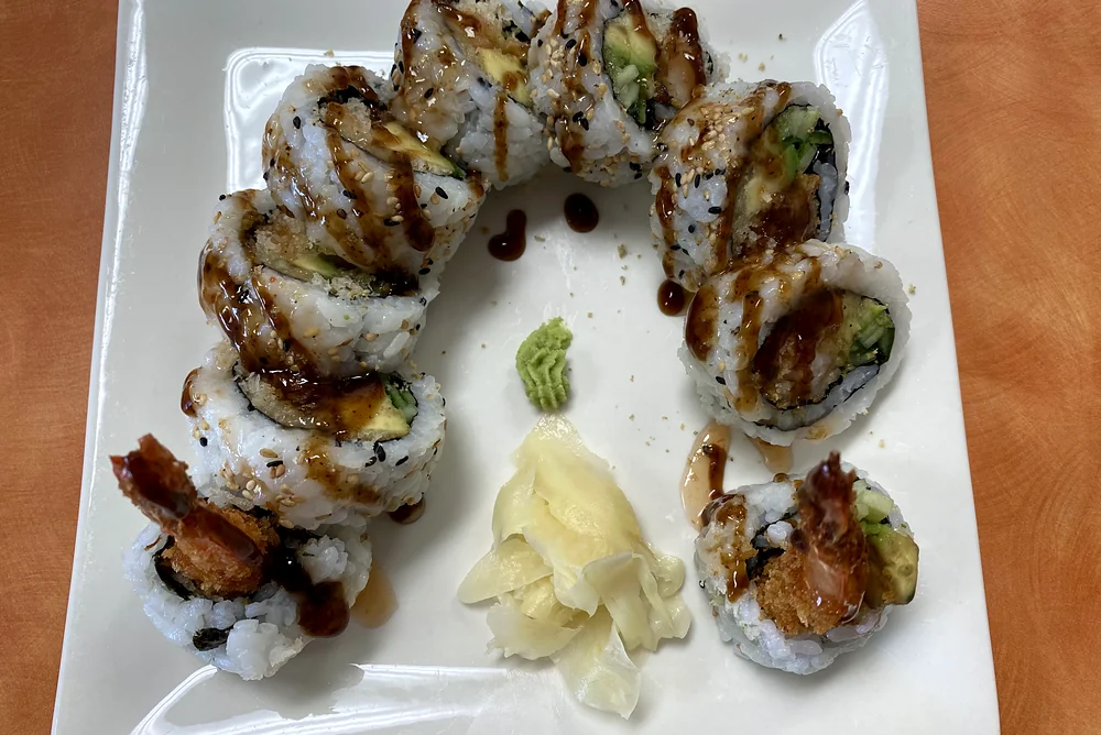 Dynamite roll with tempura shrimp, avocado and cucumber, topped with sweet sauce, with ginger and wasabi at Hana Sushi, Winnipeg