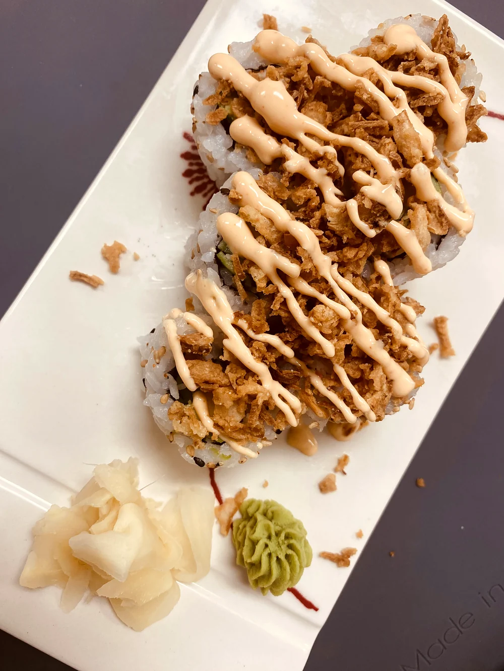 Crunchy California roll topped with crispy fried onion and creamy sauce at Hana Sushi, Winnipeg